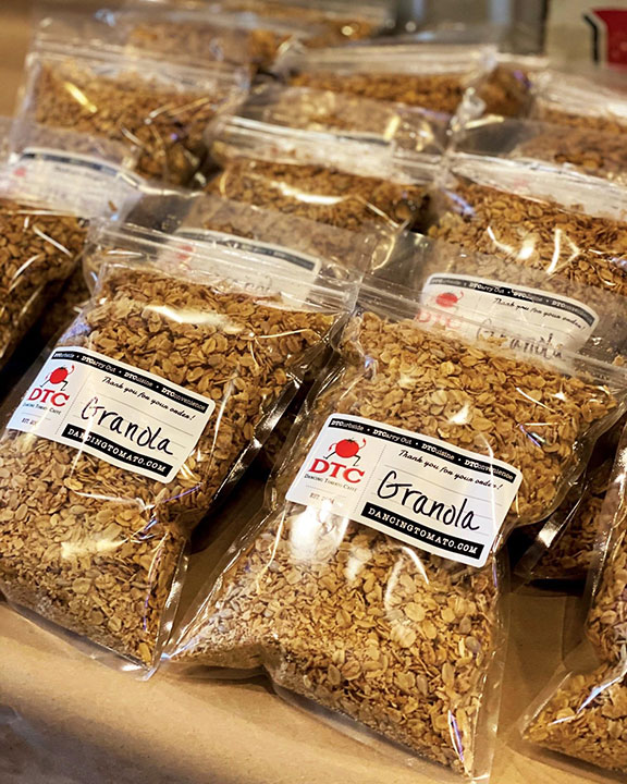 Bags of Granola sitting on a counter.